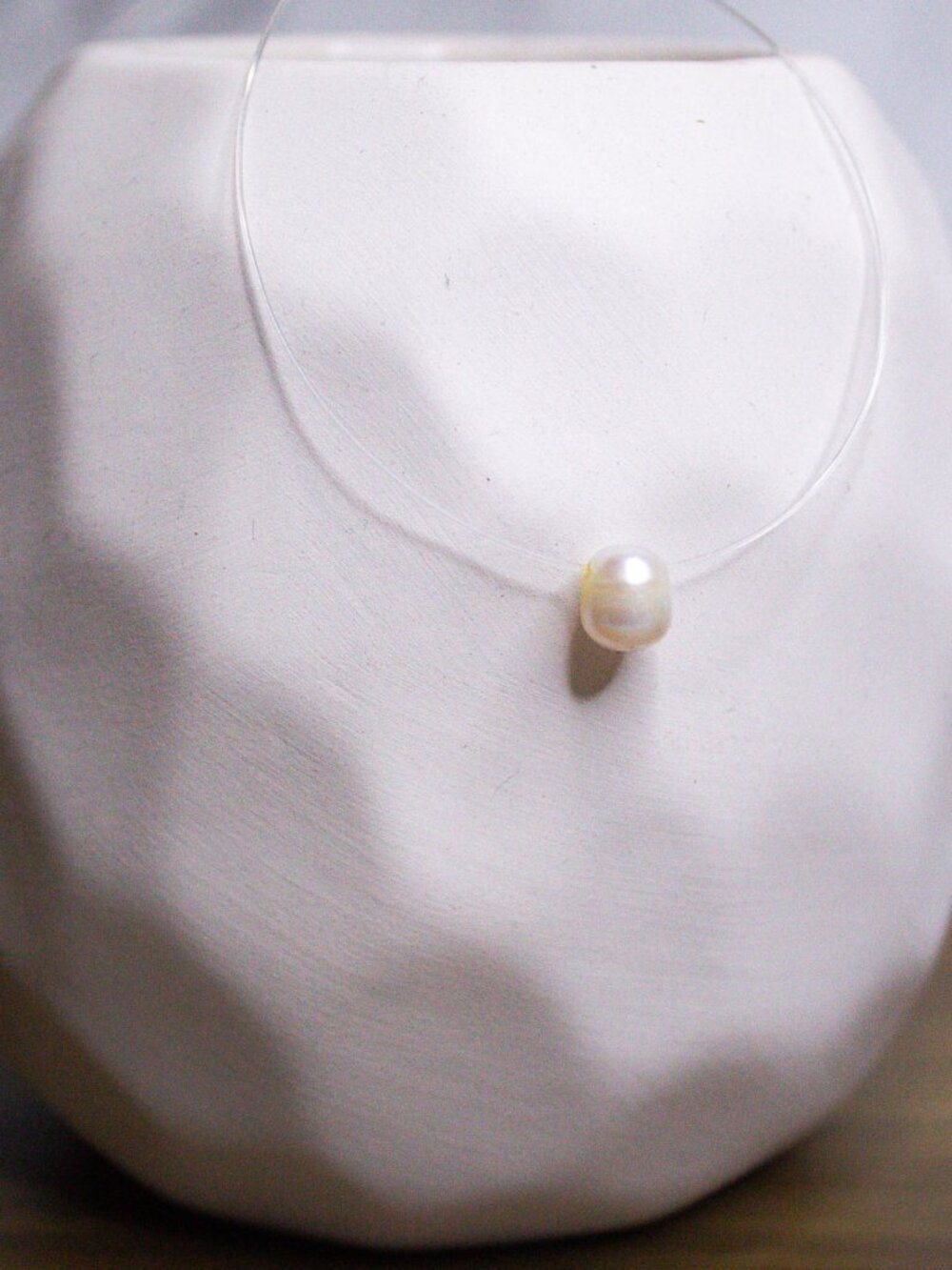 Invisible necklace with floating pearl